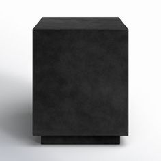 a black square object sitting on top of a white surface