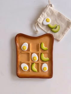 an egg and avocado sandwich on a plate next to a small drawstring bag