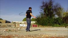 a man is playing with a frisbee in the middle of an empty lot