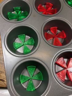 cupcake tins with red and green decorations in them