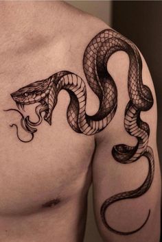 a man's chest with a snake tattoo on it