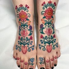 a woman's feet with flowers and hearts painted on them