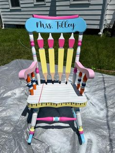 a child's rocking chair made out of crayons with the words miss tilly written on it