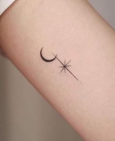 a small star and crescent tattoo on the left inner arm, which is black in color