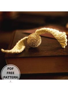 a crocheted piece of cloth sitting on top of a book