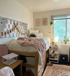 a dorm room with a bed, desk and computer