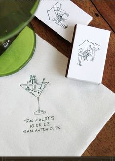 two napkins with hand drawn images on them, one has a cocktail glass and the other has a stamp