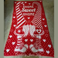 a red and white towel with gnomes on it that says gnome's sweet gnome