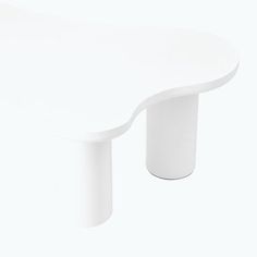 a white table sitting on top of a white floor