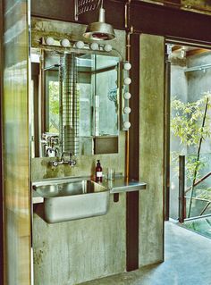 a bathroom with a sink and mirror in it