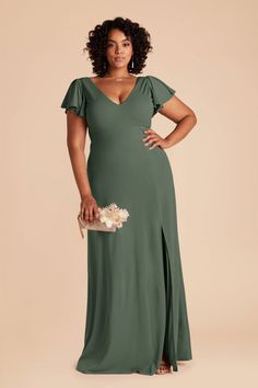 a woman in a green dress with her hands on her hips