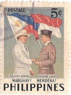 a postage stamp with two men shaking hands and the flag on top of each other