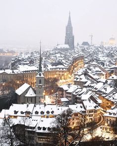 the city is covered in snow and lit up with lights