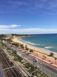 a train track next to the beach and ocean