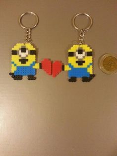 two lego minion keychains are shown next to a penny