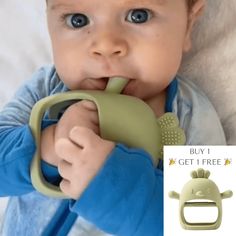 a baby chewing on a green toy with the tag buy 1 get 1 free below