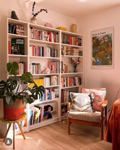 a living room filled with lots of books and furniture