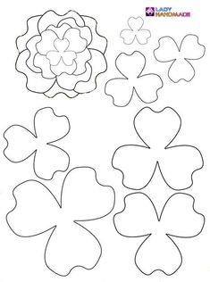 paper cut outs with four leaf clovers and one flower in the middle, on a white