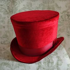 The Dandy is a simple and yet elegant victorian inspired top hat.It is covered with soft rich velvet in wine red.It is elegantly embellished with matching colored ribbon around the crown. Available in black, red(pictured) or ivory with matching ribbon. Need this TOP HAT in another color? with more decoration? Just send me a message to talk about a custom hat made just for you! This hat is fully lined with satin and it is made to according to your exact head measurement making it suitable for bot Red Satin Top, Mad Hatter Top Hat, Red Velvet Top, Steampunk Top, Mad Hat, Steampunk Top Hat, Red Gothic, Hat Aesthetic, Gothic Tops