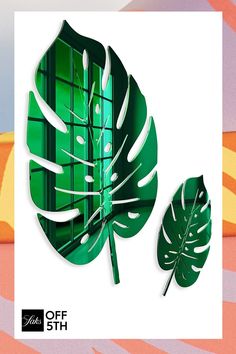 a paper cut out of a green leaf next to a window