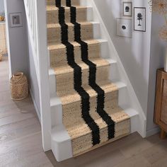 the stairs are decorated with black and white carpet