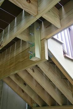 the inside of a building with wooden beams