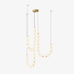 three lights hanging from the ceiling with beads attached to each light fixture, one is white and