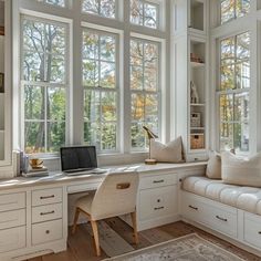 a home office with lots of windows and white furniture