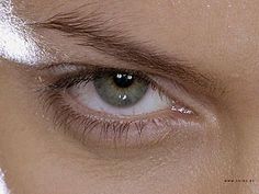 an extreme close up shot of the eye of a person with green eyeshadow