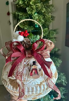 a christmas ornament hanging from the side of a tree