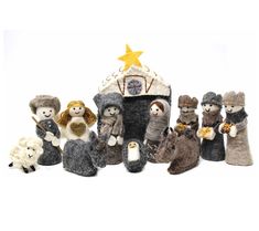 a group of stuffed animals sitting next to each other in front of a nativity scene