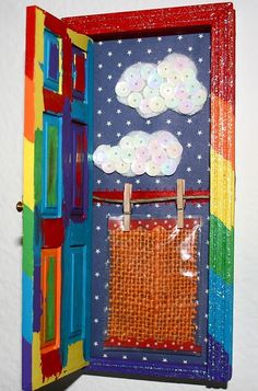 an open door with clouds and stars painted on it