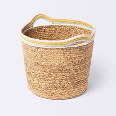 a round basket with yellow and white trimmings on the bottom, sitting against a white background