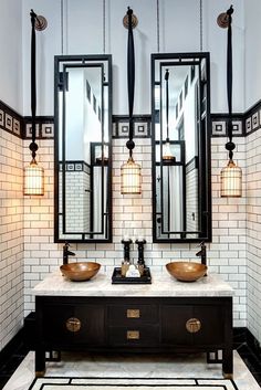 a bathroom with two sinks and mirrors in it