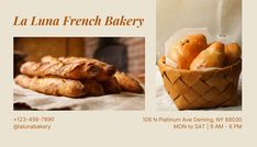 a basket full of bread sitting on top of a table next to a sign that says la luna french bakery