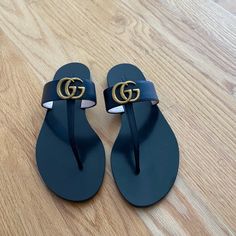 Authentic Gucci From Milan Store, Never Worn, Just Kept In Storage, Slick And Clean Leather, Slight Discoloration On G Over The Years Which Is Pictured, European Size 39 Fits U.S. Size 8.5/9 Luxury Black Leather Flip Flops, Designer Black Leather Flip Flops, Designer Black Flip Flops For Beach, Designer Black Flip Flops For The Beach, Designer Flat Flip Flops For Beach, Gucci Sandals With Branded Heel Counter For Beach, Gucci Black Sandals With Single Toe Strap, Gucci Designer Sandals With Single Toe Strap, Designer Gucci Sandals With Single Toe Strap