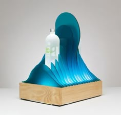 a wooden stand with a bottle on top of it and blue waves in the background