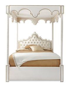 a white bed with an ornate headboard and foot board on it's sides