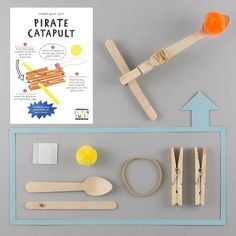 the contents of a pirate catapult are laid out on a gray surface with an arrow pointing to it