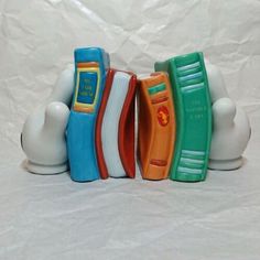 three ceramic bookends sitting on top of each other