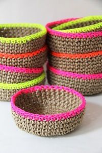 four woven baskets with neon colored handles on a white surface