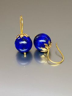 Beautiful vibrant and high-grade lapis lazuli globe earrings. The 12.5 mm lapis lazuli globes have a gorgeous deep vibrant royal blue color that shows celestial flecks of golden pyrite in the stone. The ultra-fine globes attached to a beautiful 14K gold-filled flower caps as they attached the vermeil on sterling ear wires. These are elegant and perfect earrings to go with any outfit. A pair of fine gemstone essentials. *Ball size (diameter): 12.5 mm *Metal: vermeil on sterling *Earrings drop len Royal Blue Lapis Lazuli Round Jewelry, Royal Blue Lapis Lazuli Jewelry, Royal Blue Round Lapis Lazuli Jewelry, Blue Lapis Lazuli Earrings For Formal Occasions, Formal Blue Lapis Lazuli Earrings, Blue Lapis Lazuli Earrings, Pierced Lapis Lazuli Round Jewelry, Round Lapis Lazuli Gemstone Earrings, Elegant Lapis Lazuli Earrings With Natural Stones