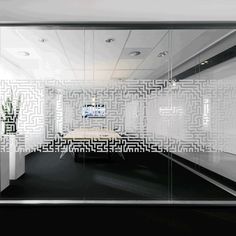 an office with white walls and black floors