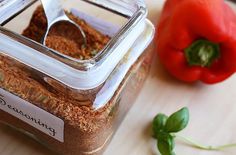 a jar filled with seasoning next to a red pepper