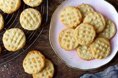 several cookies on a plate next to a cooling rack