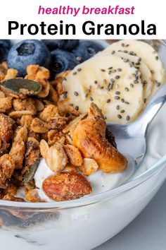 a bowl filled with granola and blueberries next to a spoon full of yogurt