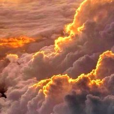 the sky is filled with fluffy clouds as the sun sets in the distance behind them