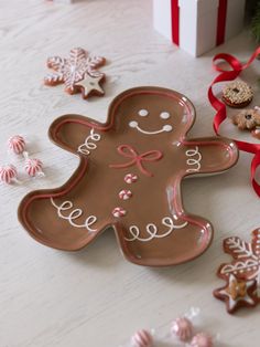 a cookie shaped like a ginger sitting on top of a table next to christmas decorations