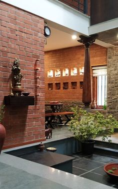 an indoor courtyard with potted plants and tables