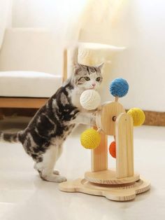 a cat standing on its hind legs playing with a wooden toy that looks like an object